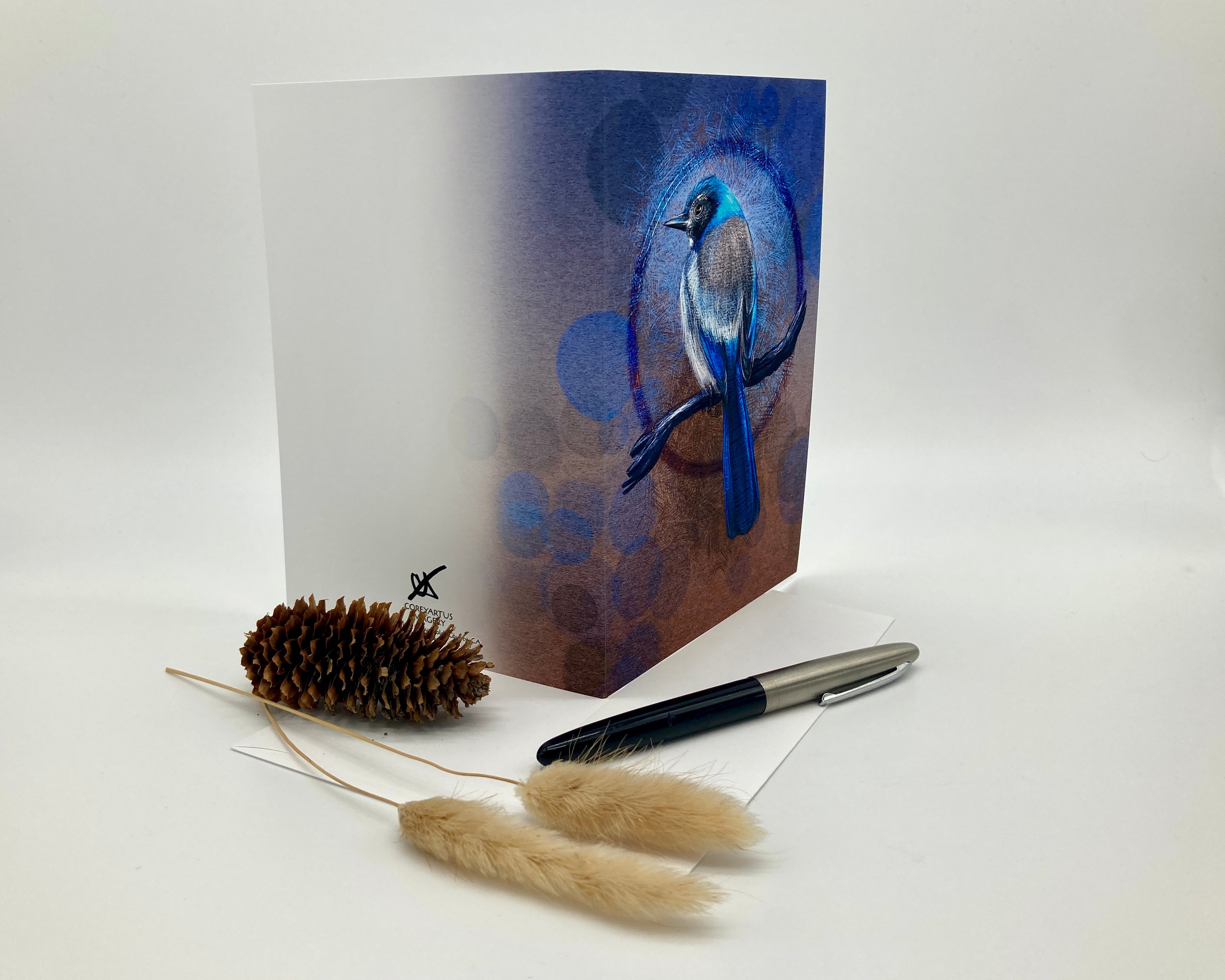 Greeting card with a blue bird design on a white background with decorative elements.
