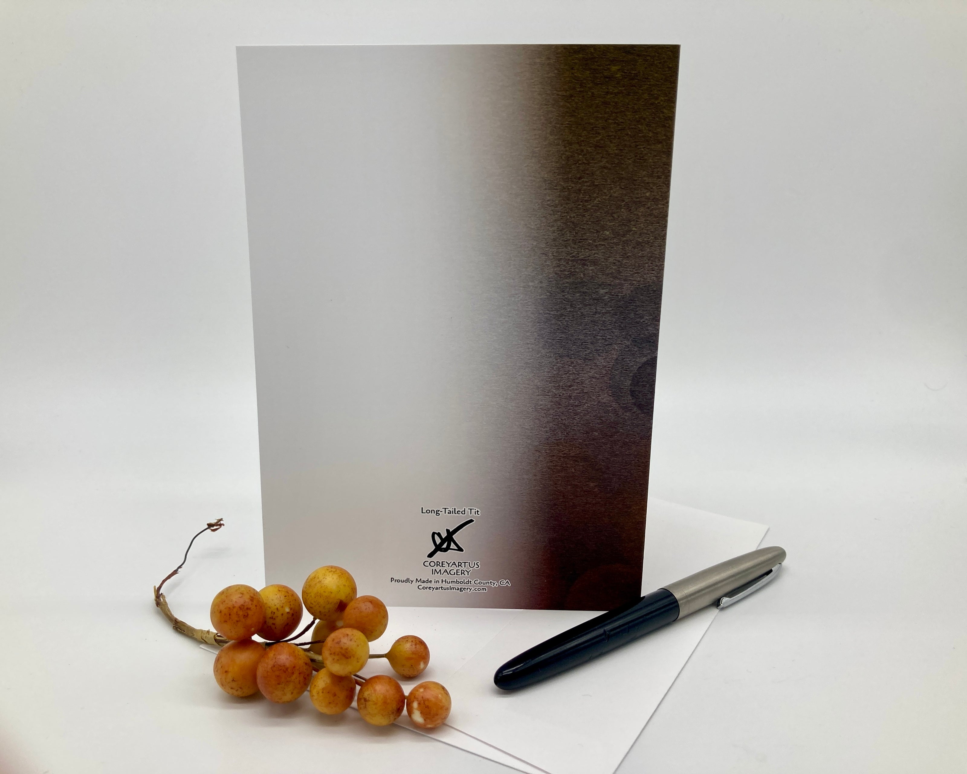 Greeting card with a pen and decorative elements on a white background