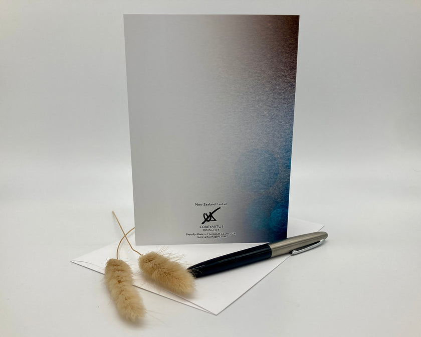 Greeting card with a pen and decorative items on a white background