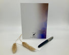 Back of a greeting card with a pen and decorative item on a white background