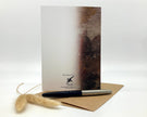 Greeting card with pen and envelope on a white background
