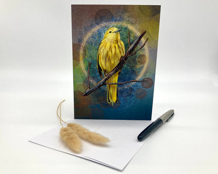 Greeting card with a yellow bird illustration on a white surface with a pen and dried plants.