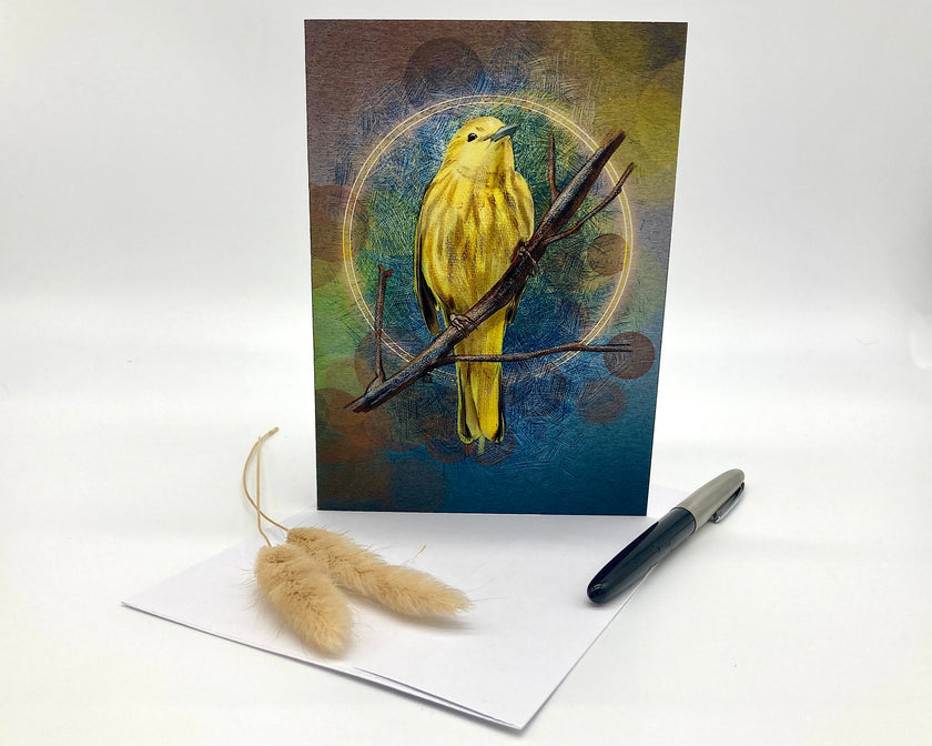 Greeting card with a yellow bird illustration on a white surface with a pen and dried plants.
