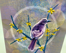 Bird perched on a branch with yellow flowers against a textured background