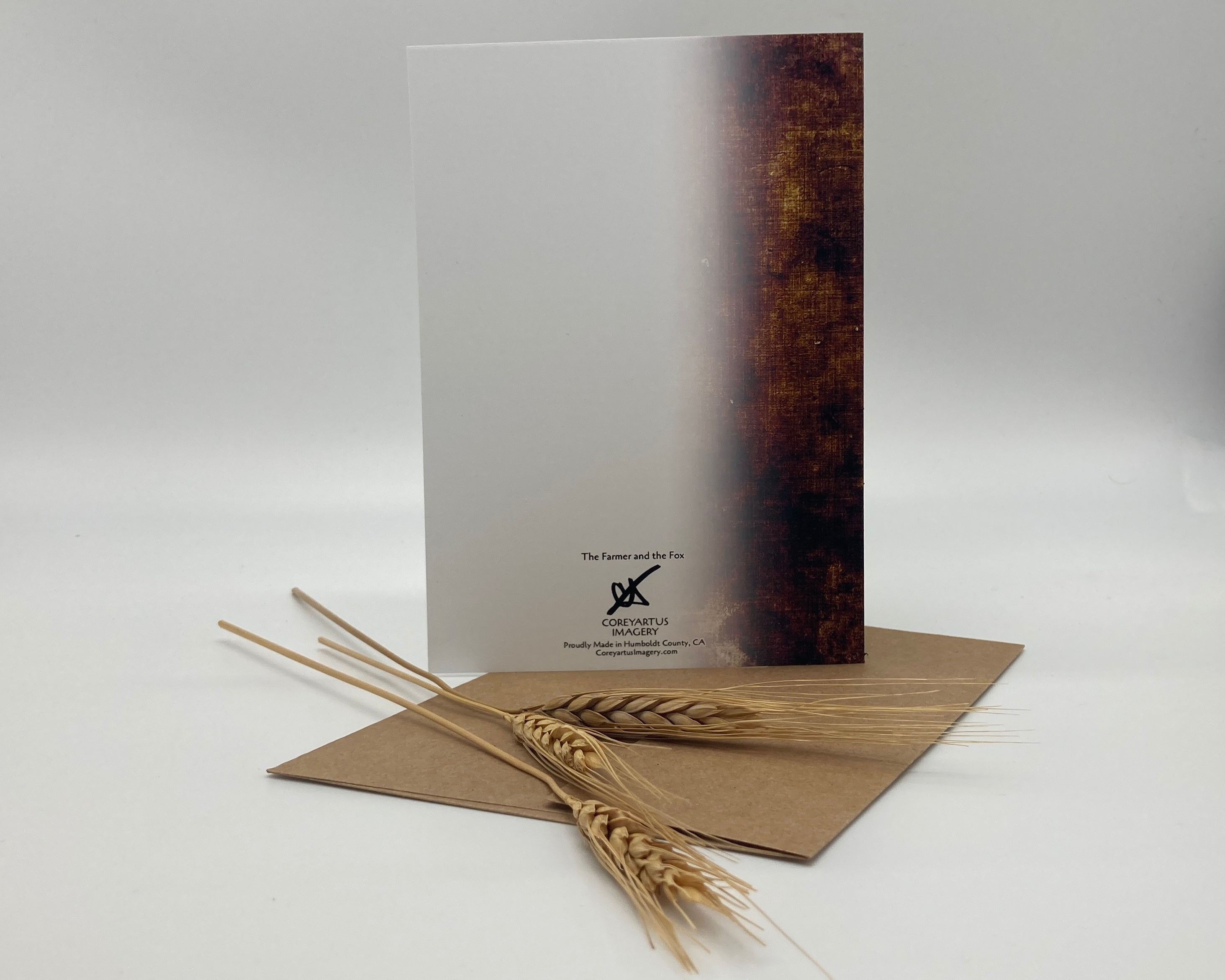 Book with a wooden cover and wheat stalk on a white background
