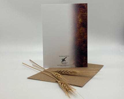 Book with a wooden cover and wheat stalk on a white background