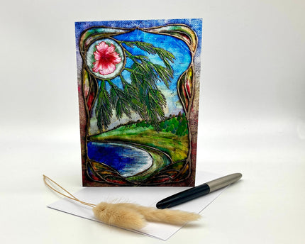 Decorative greeting card with nature-themed design, pen, and feather on a white background