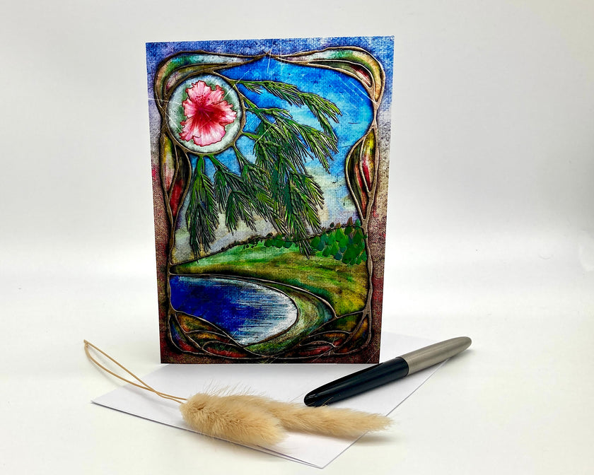 Decorative greeting card with nature-themed design, pen, and feather on a white background