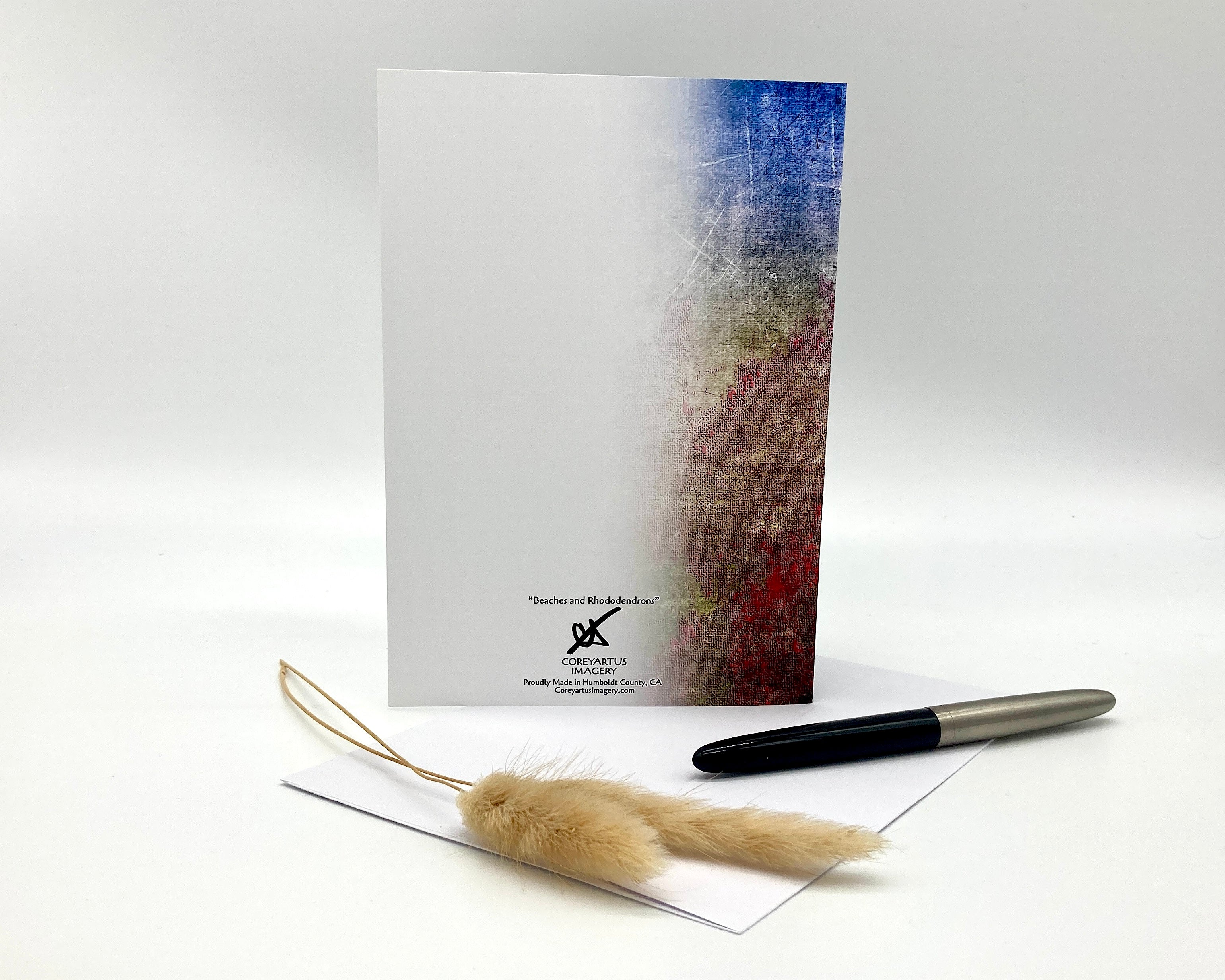 Notebook with a pen and decorative item on a white background