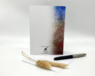Notebook with a pen and decorative item on a white background