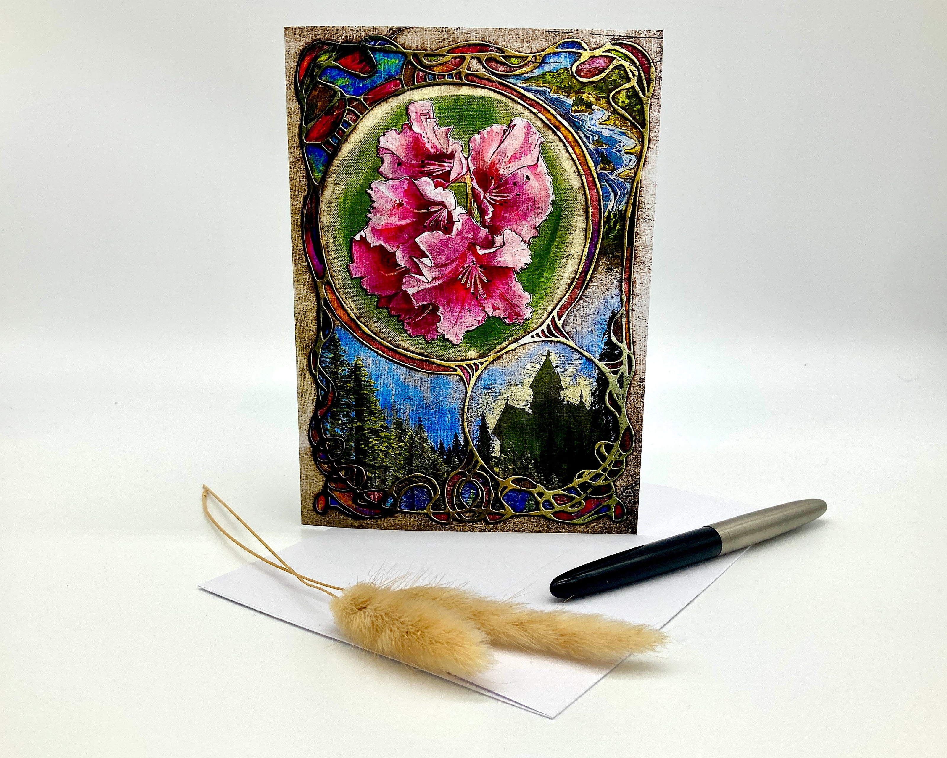 Decorative greeting card with floral design and pen on a white background