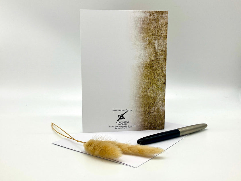 Greeting card with textured design, feather, and pen on a white background