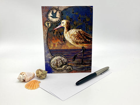 Decorative greeting card with a bird design on a white surface with shells and a pen.