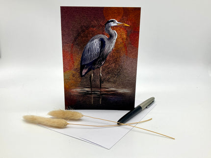 Greeting card with a heron design on a white surface with decorative elements.