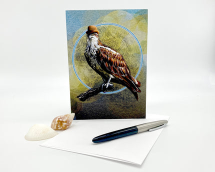 Greeting card with a bird design on a white surface with a pen and shell.