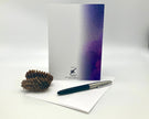 Greeting card with purple gradient, pen, and pine cone on a white background