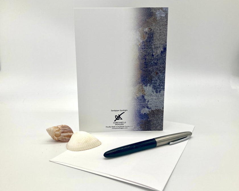 Notebook with a pen and shell on a white background