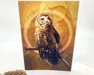 Card with an owl design on a gold background
