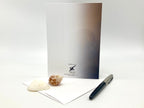 Greeting card with envelope and pen on a white background