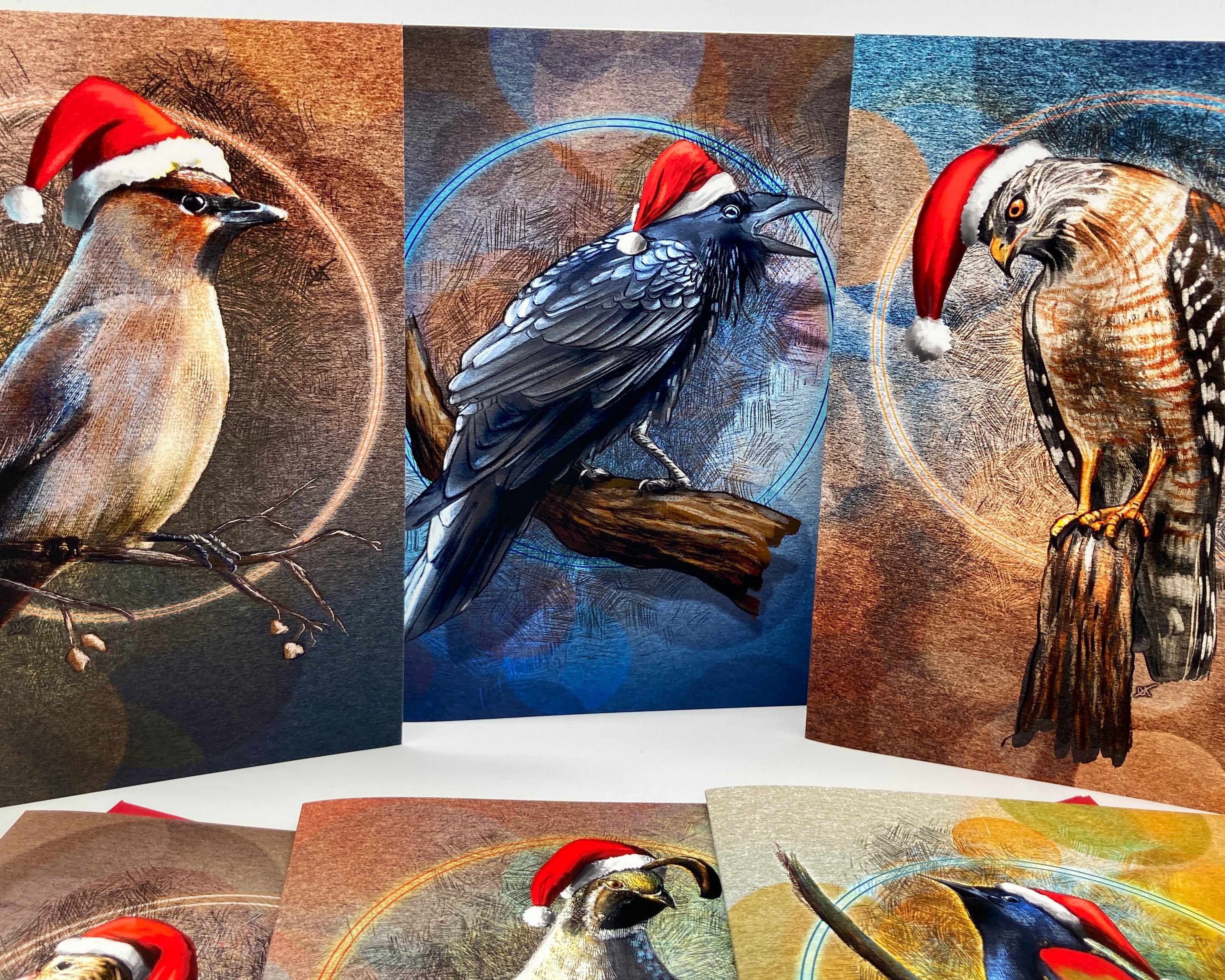 Set of greeting cards with birds wearing Santa hats on a white background