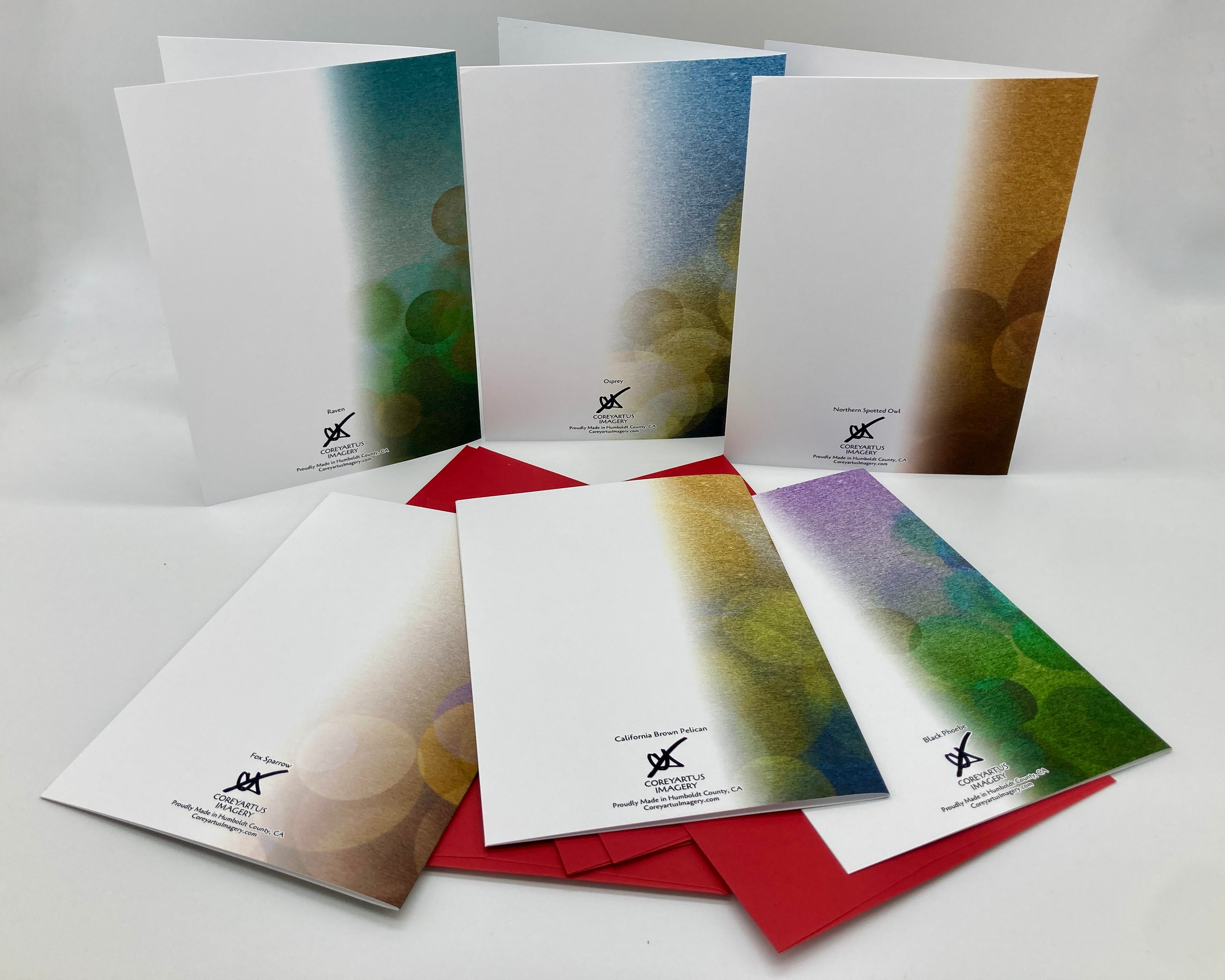 Backside of six greeting cards with artistic designs on a gray background