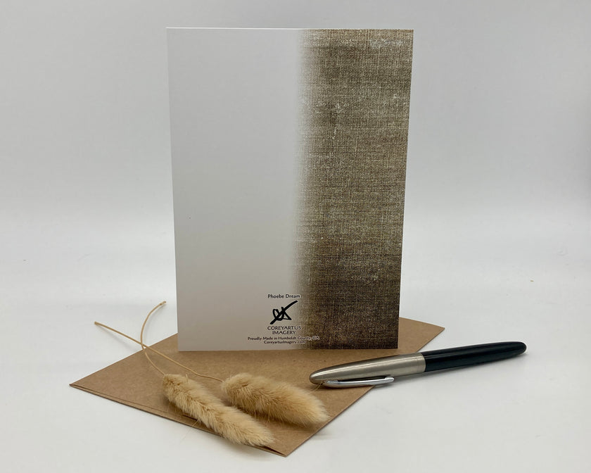 Greeting card with textured design, pen, and dried plants on a white background