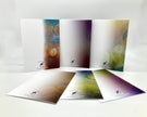 Set of open brochures with colorful abstract designs on a white background
