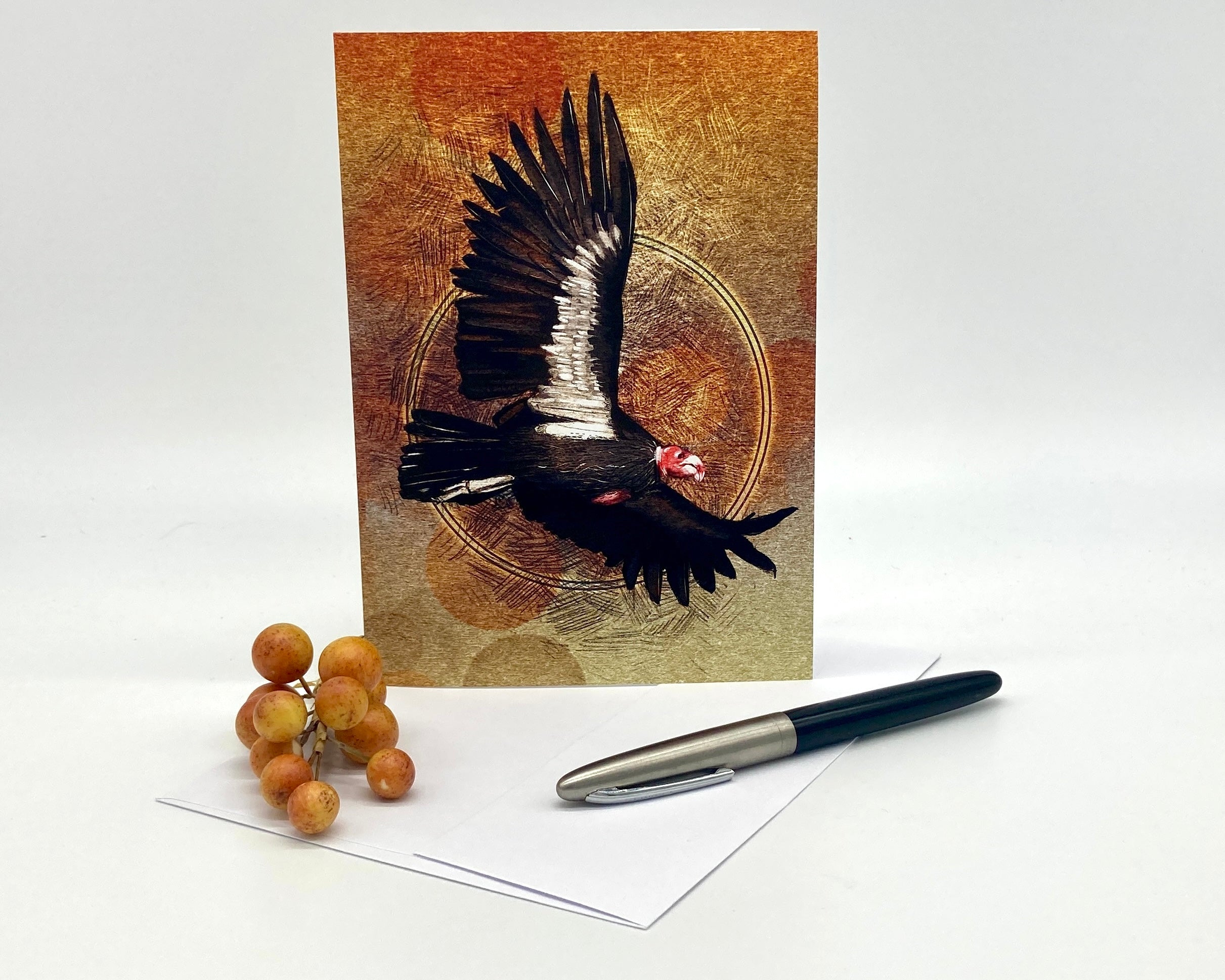 Greeting card with a bird design on a white background with a pen and berries.