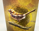 Illustration of a bird perched on a branch with a yellow circle in the background