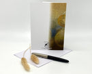 Greeting card with abstract design, pen, and decorative elements on a white background