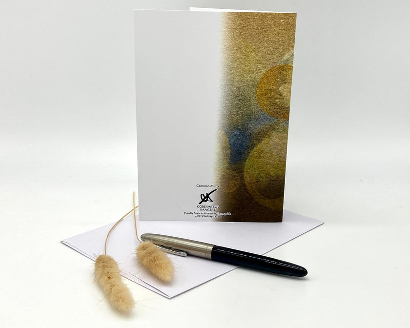 Greeting card with abstract design, pen, and decorative elements on a white background