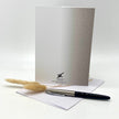 Backside of a greeting card with props, arranged against a white background.
