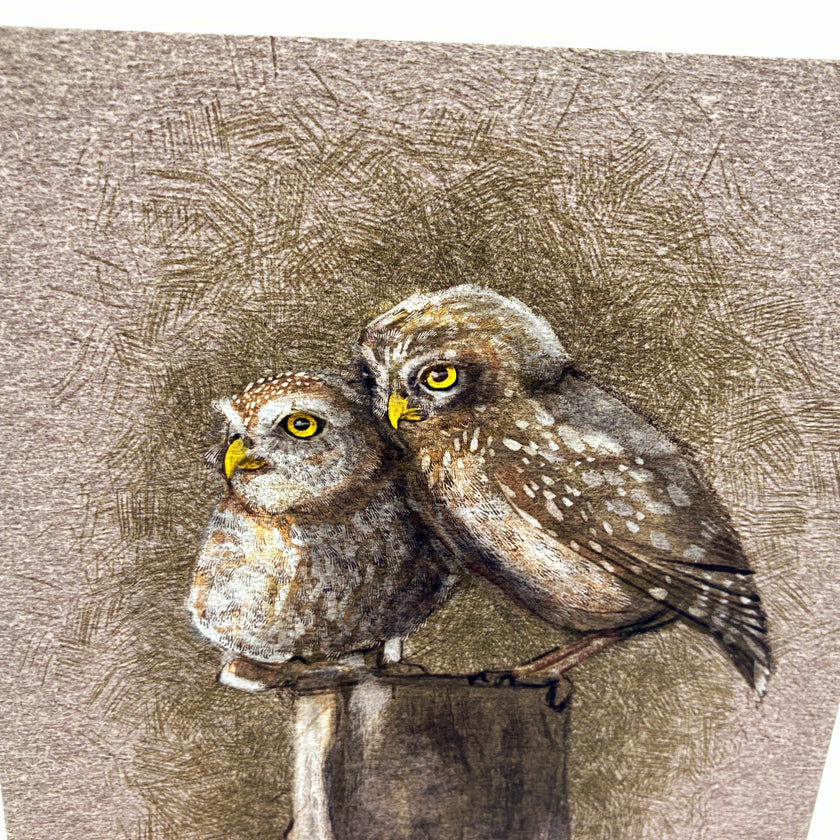 Two owls perched on a branch with a textured brown background