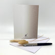 Backside of a greeting card with props, arranged against a white background.