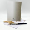Greeting card with pen and envelope on a white background