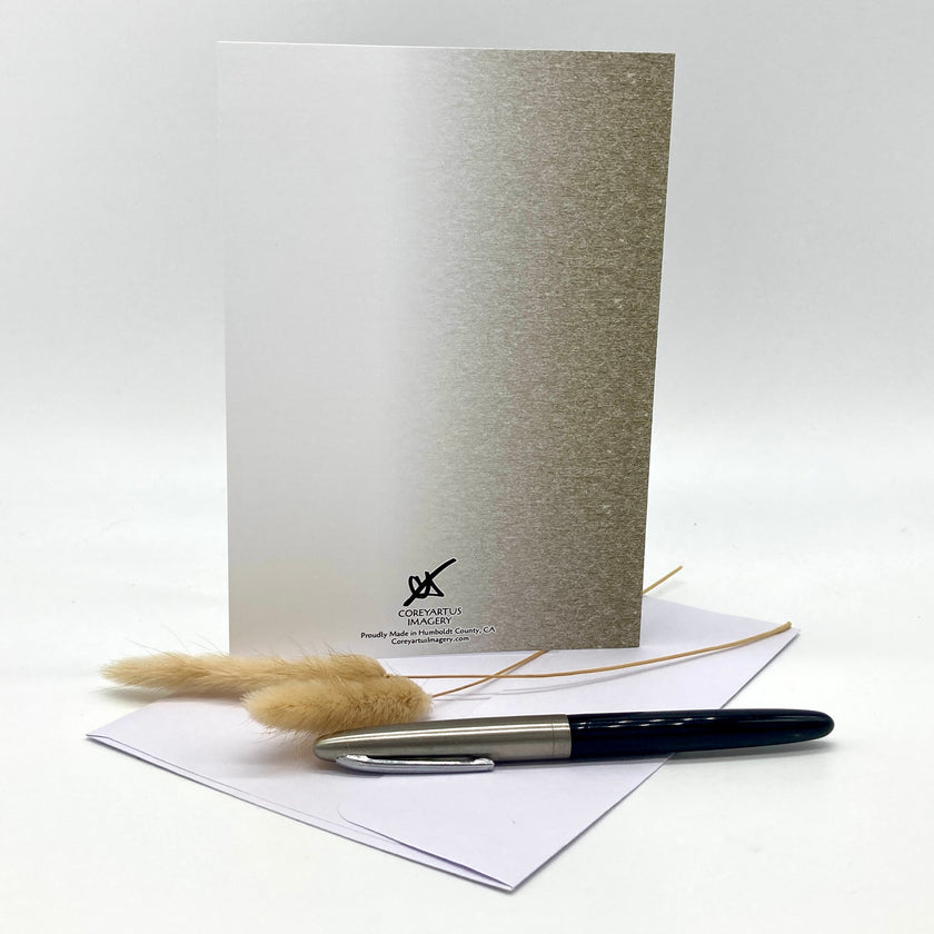 Greeting card with pen and envelope on a white background