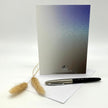 Greeting card with a pen and decorative elements on a white background