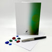Card with green gradient design, pen, and color swatches on a white background