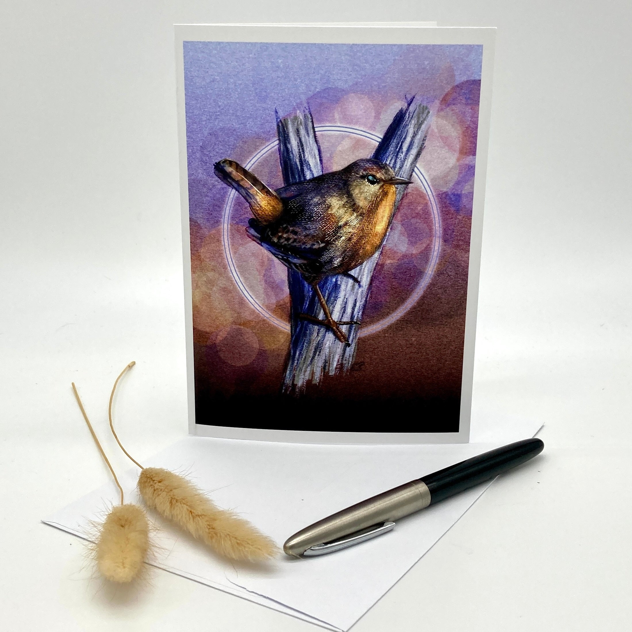 Product photo of a greeting card with a Pacific Wren in browns and purples.