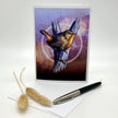 Product photo of a greeting card with a Pacific Wren in browns and purples.