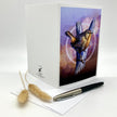 Product photo of the backside of a greeting card splayed out open with a Pacific Wren in browns and purples.