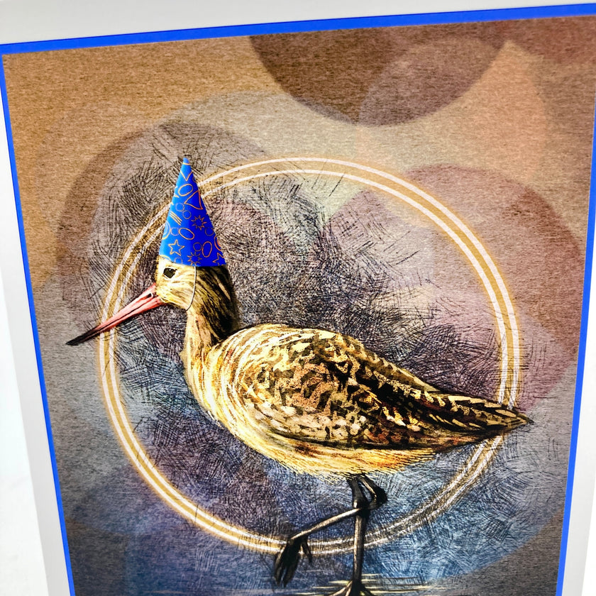 Closeup of a birthday card featuring a marbled Godwit in a blue party hat.