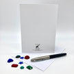 Backside of a greeting card posed with plastic rhinestone shapes.