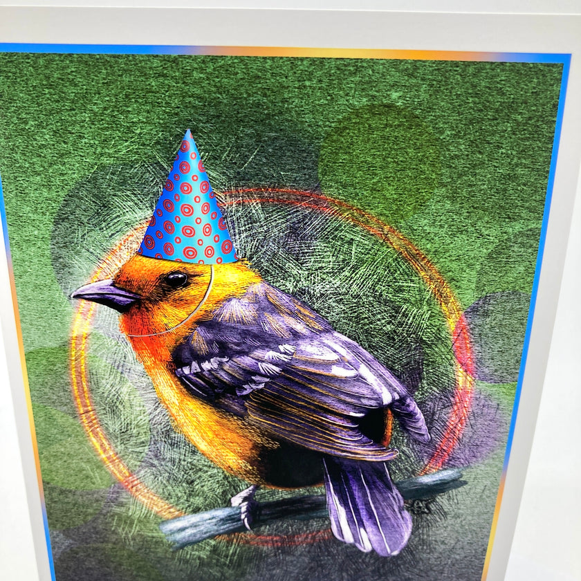 A colorful art print depicting an orange and black bird perched on a branch, wearing a blue party hat with red polka dots, set against a textured green background with circular graphic elements.