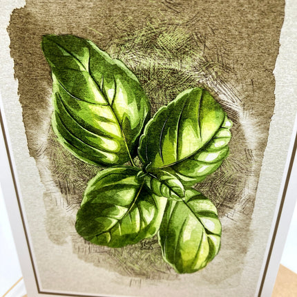 A botanical art print featuring a detailed illustration of fresh green basil leaves on a textured beige and brown background.