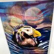 A close-up of a colorful artwork depicting a puffin in blue water with abstract bokeh-like circles in the background.