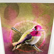 A art print greeting card featuring a hummingbird perched on branches with a glowing circular motif and pink-toned background.