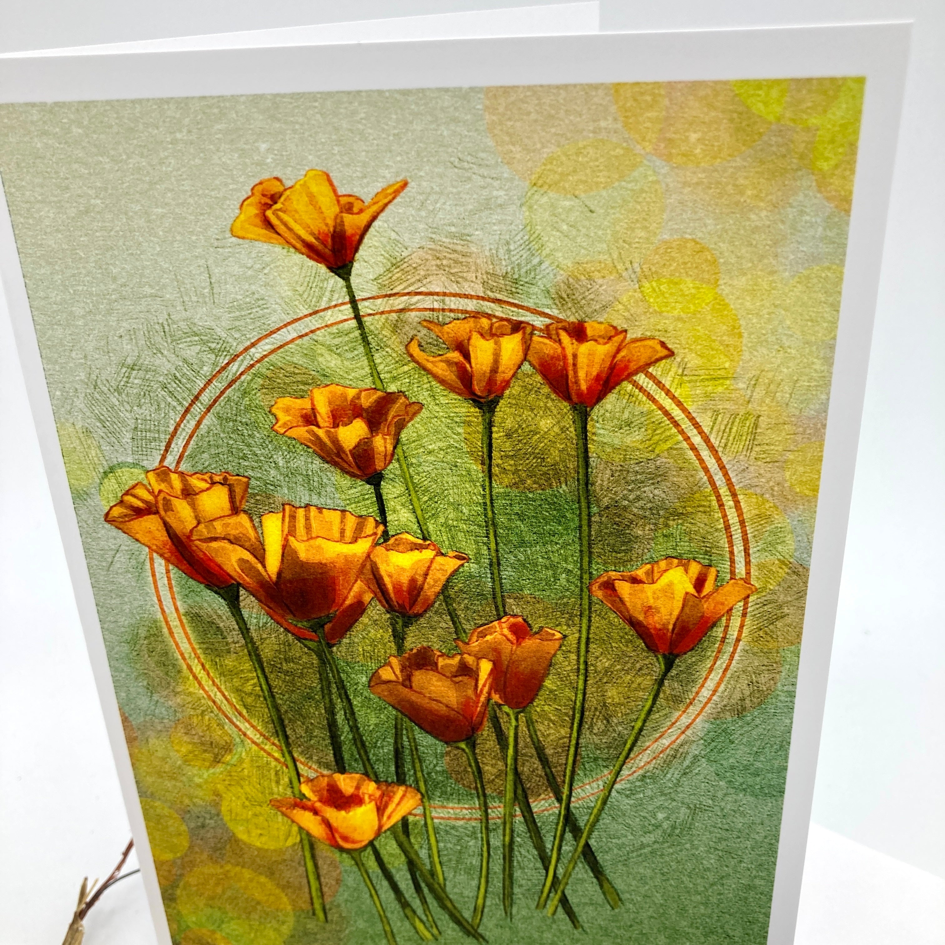 A square art print or card featuring a cluster of orange poppy flowers with green stems on a textured light green and yellow background, photographed standing against a white surface.