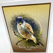 An art print or card featuring a detailed illustration of a bird of prey perched on a branch, wearing a small black bowler hat. The artwork has a textured gold background with a dark circular sketch behind the bird and the text 'Keep it classy.