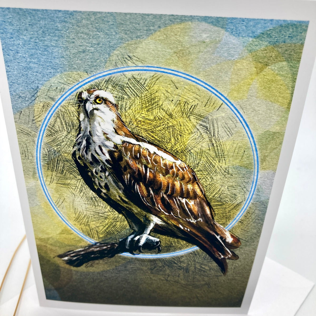 A card featuring a detailed illustration of an owl perched on a branch, with a blue circular outline behind it and a textured abstract background in muted blue, olive, and beige tones.
